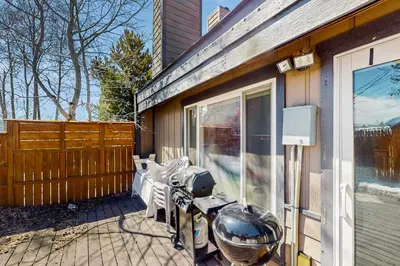 a patio with a table and chairs on a house at Mountain Dreams Condo in Fraser
