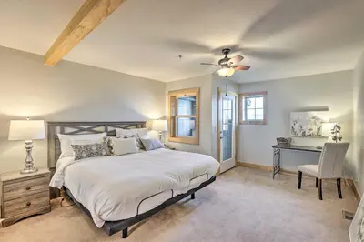 a bedroom with a bed with a ceiling fan and a desk at 7 Mi to Slopes Main Street Condo in Dillon in Dillon