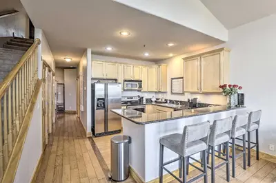 a kitchen with a bar with stools and a counter top at 7 Mi to Slopes Main Street Condo in Dillon in Dillon