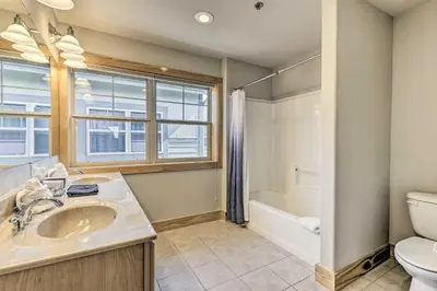 a bathroom with a sink and a toilet and a window at 7 Mi to Slopes Main Street Condo in Dillon in Dillon