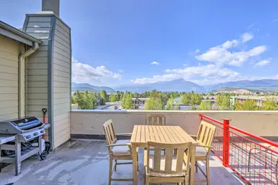 a table and chairs on a balcony with a grill at 7 Mi to Slopes Main Street Condo in Dillon in Dillon