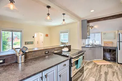 a large kitchen with stainless steel appliances and a counter top at Modern House with Yard Less Than 7 Mi to Downtown Denver! in Denver