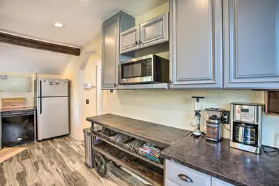 a kitchen with a counter top and a refrigerator at Modern House with Yard Less Than 7 Mi to Downtown Denver! in Denver