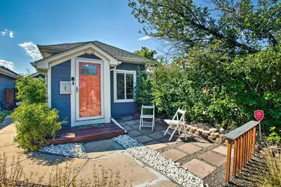 a blue house with a red door and a chair at Modern House with Yard Less Than 7 Mi to Downtown Denver! in Denver