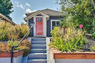 a blue house with a red door and a stop sign at Modern House with Yard Less Than 7 Mi to Downtown Denver! in Denver
