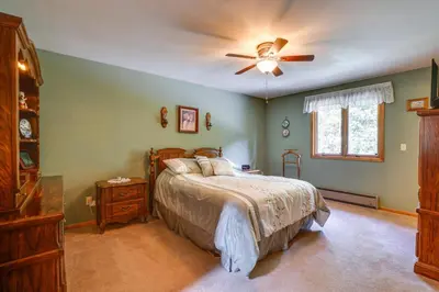a bedroom with a bed and a ceiling fan at Silver Plume Mountain Haven with Views and Deck! in Silver Plume