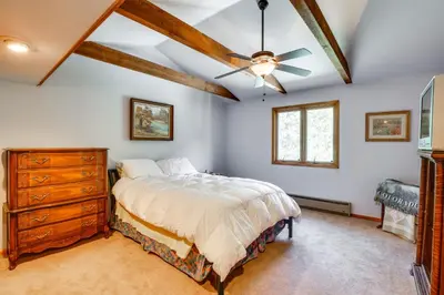 a bedroom with a bed and a ceiling fan at Silver Plume Mountain Haven with Views and Deck! in Silver Plume