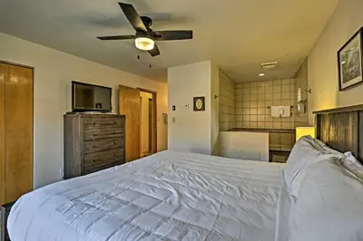 a bedroom with a large bed with a ceiling fan at Less Than 2 Mi to Frisco Adventure Park Cozy Townhome! in Frisco