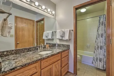a bathroom with a sink and a large mirror at Less Than 2 Mi to Frisco Adventure Park Cozy Townhome! in Frisco