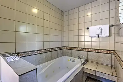 a bathroom with a tub and a sink at Less Than 2 Mi to Frisco Adventure Park Cozy Townhome! in Frisco