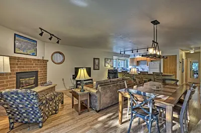 a living room with a couch and a table and a fireplace at Less Than 2 Mi to Frisco Adventure Park Cozy Townhome! in Frisco