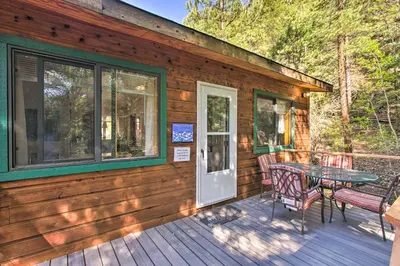 a cabin with a table and chairs on a deck at Chicago Creek B and B 1 Mi to Mt Blue Sky! in Idaho Springs