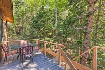 a wooden deck with a table and chairs on it at Chicago Creek B and B 1 Mi to Mt Blue Sky! in Idaho Springs