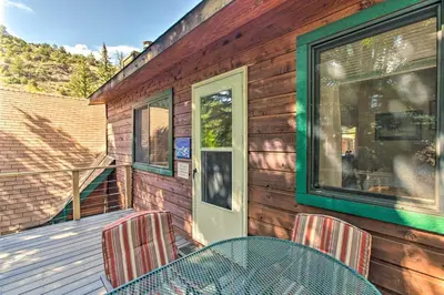 a patio with a table and chairs on a deck at Chicago Creek B and B 1 Mi to Mt Blue Sky! in Idaho Springs