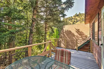 a deck with a table and chairs on a house at Chicago Creek B and B 1 Mi to Mt Blue Sky! in Idaho Springs