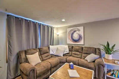 a living room with a couch and a table at Loveland Getaway with Fire Pit and Ping Pong Table! in Loveland