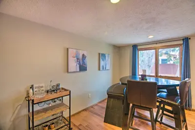 a dining room with a table and chairs and a window at Loveland Getaway with Fire Pit and Ping Pong Table! in Loveland
