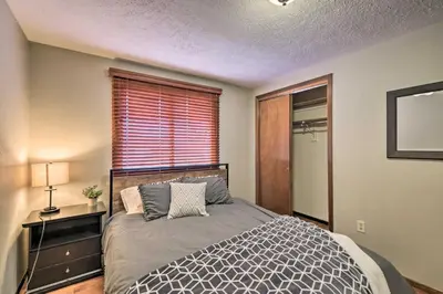 a bedroom with a large bed and a window at Loveland Getaway with Fire Pit and Ping Pong Table! in Loveland