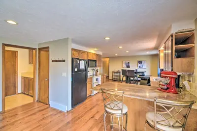 a kitchen with a counter and chairs in a room at Loveland Getaway with Fire Pit and Ping Pong Table! in Loveland