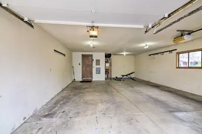 an empty room with a concrete floor and a door at Loveland Getaway with Fire Pit and Ping Pong Table! in Loveland