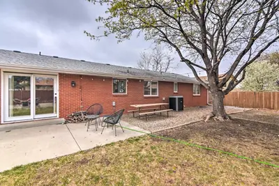 a house with a picnic table and chairs in the yard at Loveland Getaway with Fire Pit and Ping Pong Table! in Loveland