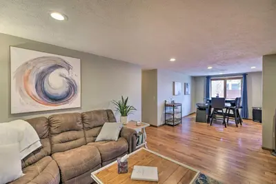 a living room with a couch and a table at Loveland Getaway with Fire Pit and Ping Pong Table! in Loveland