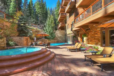 a patio with a hot tub in a yard at 3066 Timbers condo in Keystone