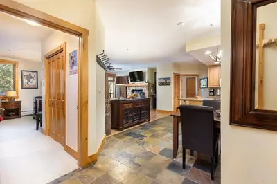 a kitchen and dining room with a table and a counter at 3066 Timbers condo in Keystone