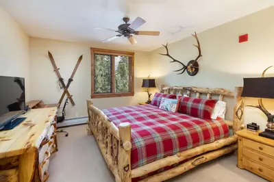 a bedroom with a bed and a flat screen tv at 3066 Timbers condo in Keystone