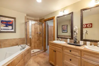 a bathroom with two sinks and a tub and a shower at 3066 Timbers condo in Keystone