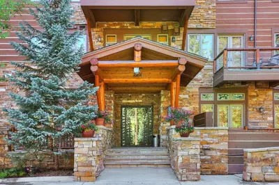 a house with a staircase leading to the front door at 3066 Timbers condo in Keystone