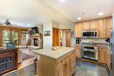 a large kitchen with wooden cabinets and a stove top oven at 3066 Timbers condo in Keystone