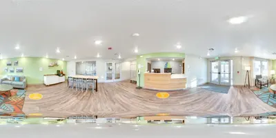 a large living room with a large wooden floor at WoodSpring Suites Thornton-North Denver in Thornton