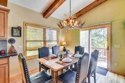 a dining room with a table and chairs at 1 Mi to Grand Lake Family-Friendly Gem with Hot Tub in Grand Lake