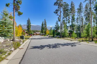 an empty road with trees on either side at 1 Mi to Grand Lake Family-Friendly Gem with Hot Tub in Grand Lake