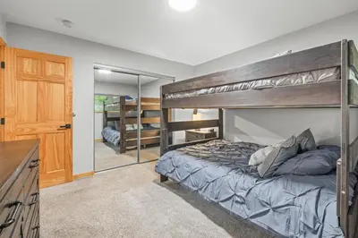 a bedroom with a bunk bed and a mirror at Cutty Sark Grand Combo 6BR 4,5BA townhouse in Silverthorne