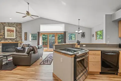 a kitchen and living room with a stove top oven at Cutty Sark Grand Combo 6BR 4,5BA townhouse in Silverthorne