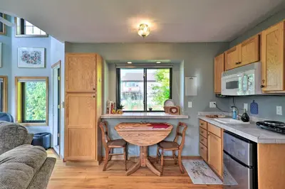 a kitchen with a table and chairs in a room at Loveland Guest House with Balcony by Boyd Lake in Loveland