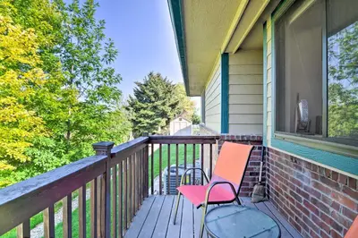 a deck with a chair on a house at Loveland Guest House with Balcony by Boyd Lake in Loveland