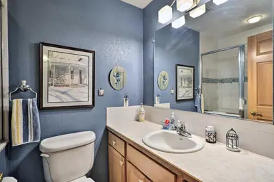a bathroom with a sink and a toilet and a mirror at Loveland Guest House with Balcony by Boyd Lake in Loveland