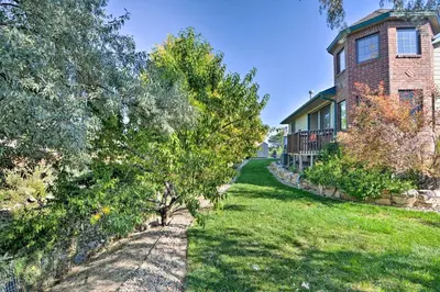 a house with a tree in the yard at Loveland Guest House with Balcony by Boyd Lake in Loveland