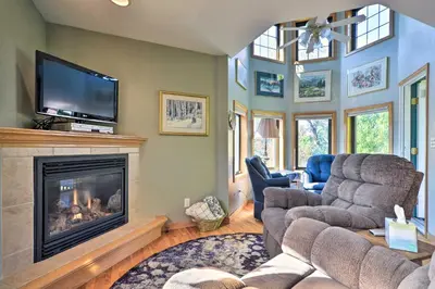 a living room with a fireplace and a flat screen tv at Loveland Guest House with Balcony by Boyd Lake in Loveland