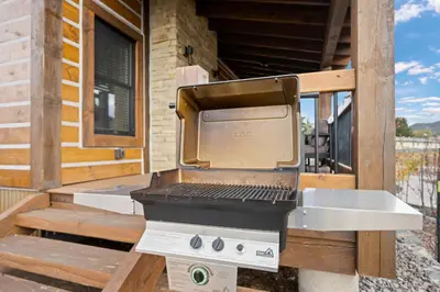 a grill sitting on a porch of a house at Slice of Heaven just steps from Lake Estes! Indoor/Outdoor Fireplace and Jacuzzi in Estes Park
