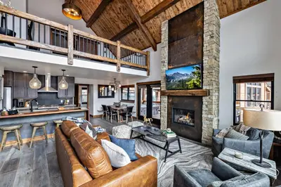 a living room with couches and a fireplace at Slice of Heaven just steps from Lake Estes! Indoor/Outdoor Fireplace and Jacuzzi in Estes Park