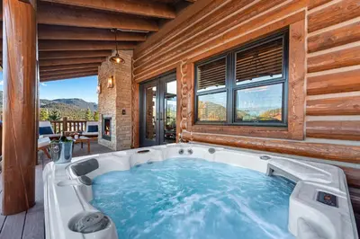 a jacuzzi tub in a room with a view at Gorgeous Views! Two large Patios, Jacuzzi, Indoor/Outdoor Fireplace in Estes Park