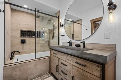 a bathroom with a sink and a mirror at Gorgeous Views! Two large Patios, Jacuzzi, Indoor/Outdoor Fireplace in Estes Park