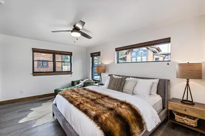 a bedroom with a bed and a ceiling fan at Gorgeous Views! Two large Patios, Jacuzzi, Indoor/Outdoor Fireplace in Estes Park