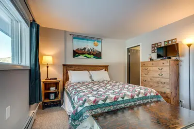 a bedroom with a bed and a dresser at 7 Mi to Ski Resort Dillon Condo with Mtn Views in Dillon