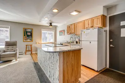 a kitchen with a white refrigerator and a counter at 7 Mi to Ski Resort Dillon Condo with Mtn Views in Dillon