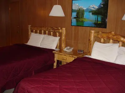 a hotel room with two beds and a table with a phone at Georgetown Mountain Inn in Georgetown